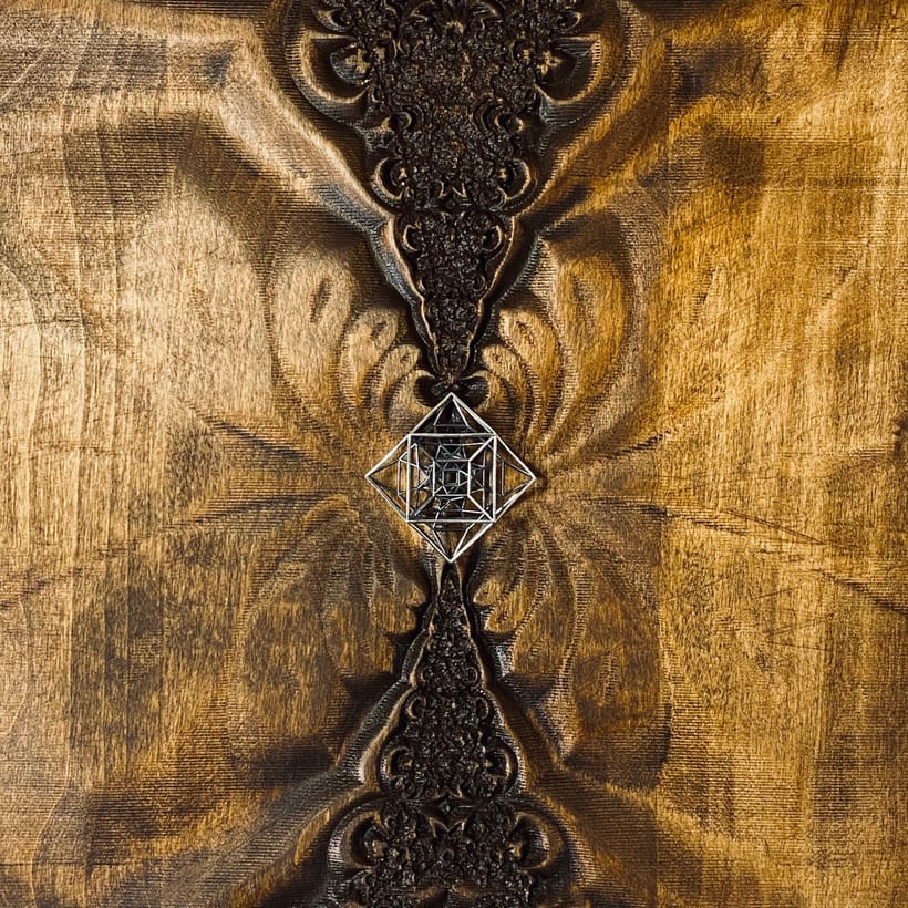 Jiva — a fractal CNC carving in stained aspen with a lost-wax cast metal 48-cell polytope inlaid at the centre